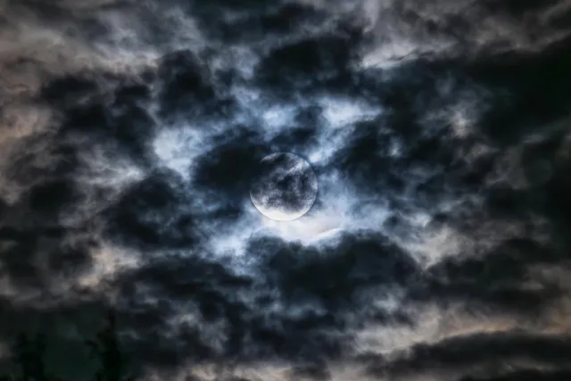 Super moon as a blue moon behind clouds over Röttgen in Hennef